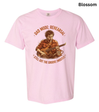 A light pink short-sleeve t-shirt with a vintage-style graphic of a man playing an acoustic guitar, surrounded by the text 'DAD MODE: REHEARSAL' and 'STILL GOT THE GROOVE (MOSTLY)'. The word 'Blossom' is printed in black in the top right corner.