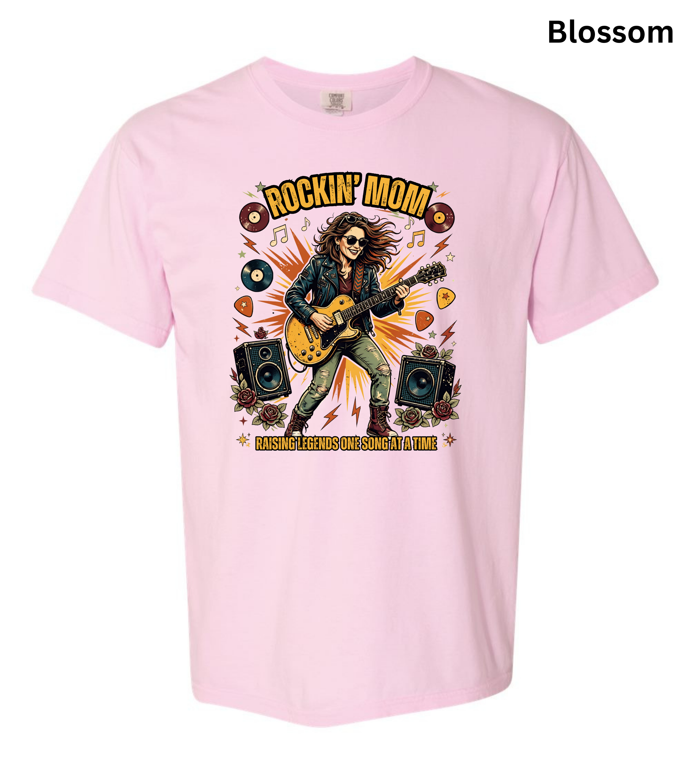 A blossom t-shirt with a colorful graphic of a rock star playing an electric guitar, surrounded by vinyl records, speakers, and guitar picks. The text 'ROCKIN' MOM' is printed above, and 'MASHING ROCKS OUT SOONLY OUTFIT' is printed below.