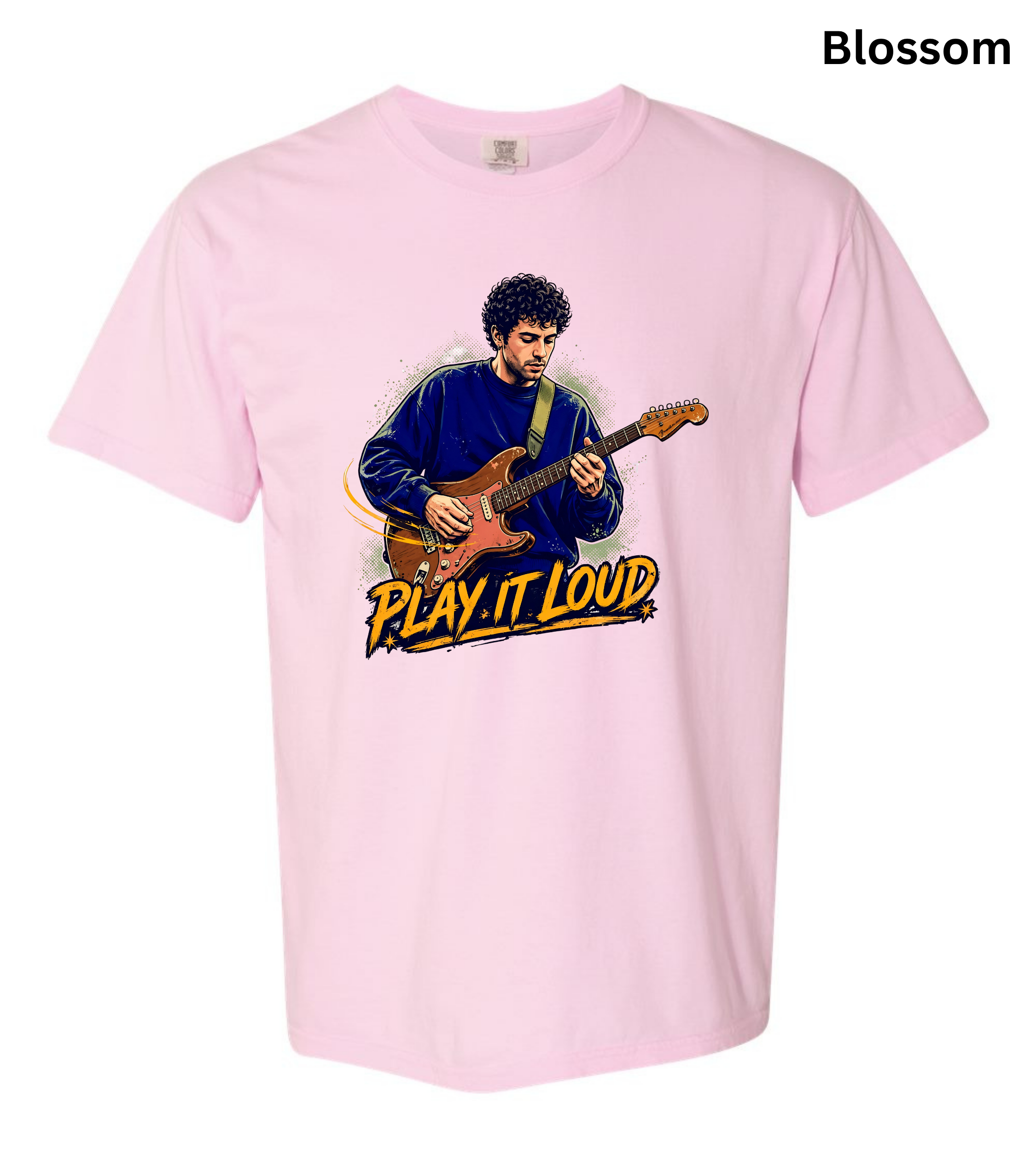 A light pink short-sleeve t-shirt with a graphic print of a man playing an electric guitar and the text 'PLAY IT LOUD' in yellow and black. The word 'Blossom' is printed in black in the top right corner.