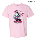 A light pink short-sleeve crewneck t-shirt featuring a colorful graphic of a man playing an electric guitar with the text 'SLAP HAPPY' printed below it. The word 'Blossom' is written in black text in the top right corner.