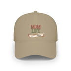 A beige baseball cap featuring a front graphic that reads 'MOM LIFE' with 'COFFEE & MUSIC' on a banner below, shown on a plain white background.