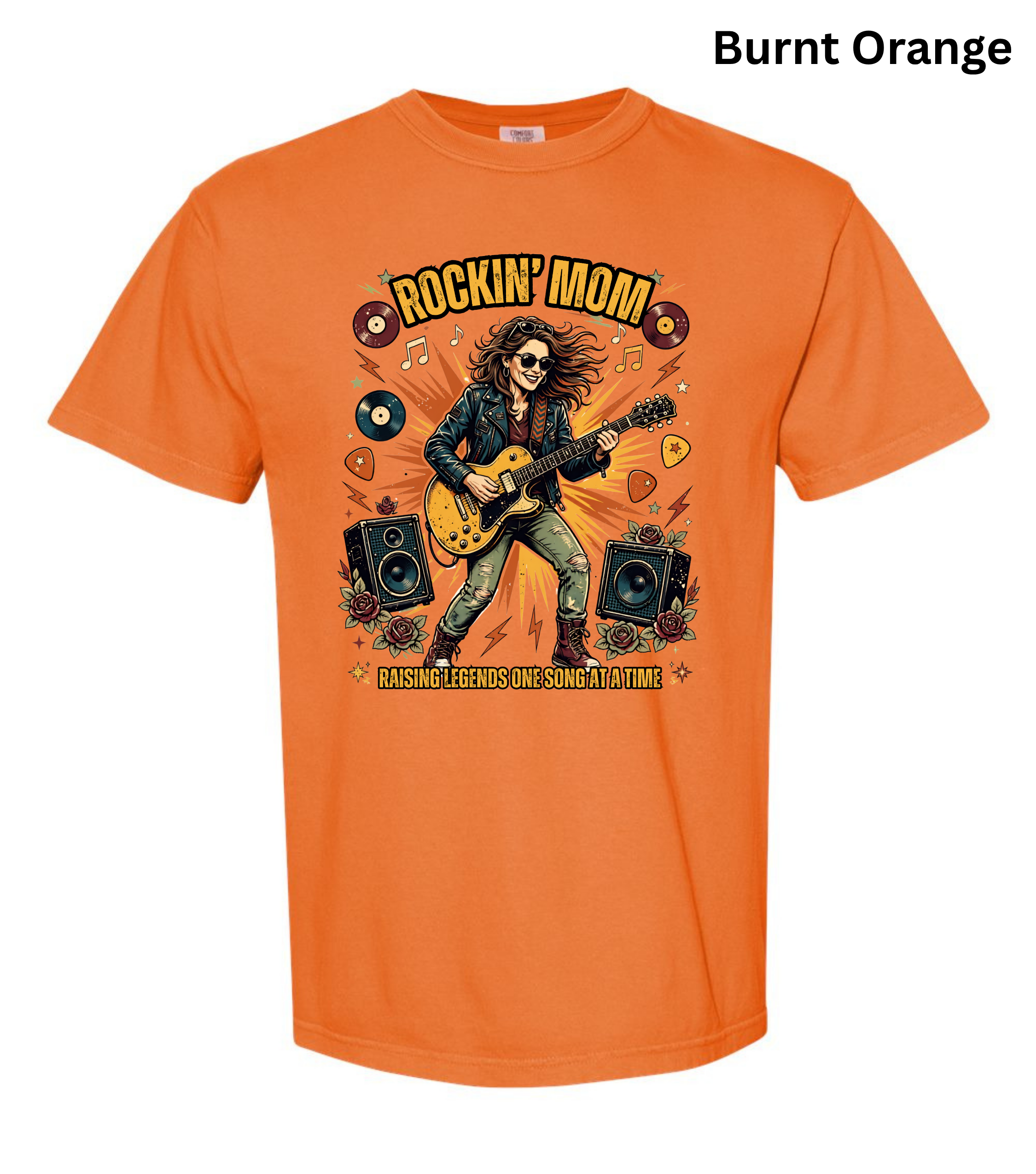 An orange short-sleeve t-shirt with a 'Rockin' Mom' graphic on the front, featuring a woman playing a guitar with speakers and vinyl records. The text 'Burnt Orange' is printed in black at the top right.