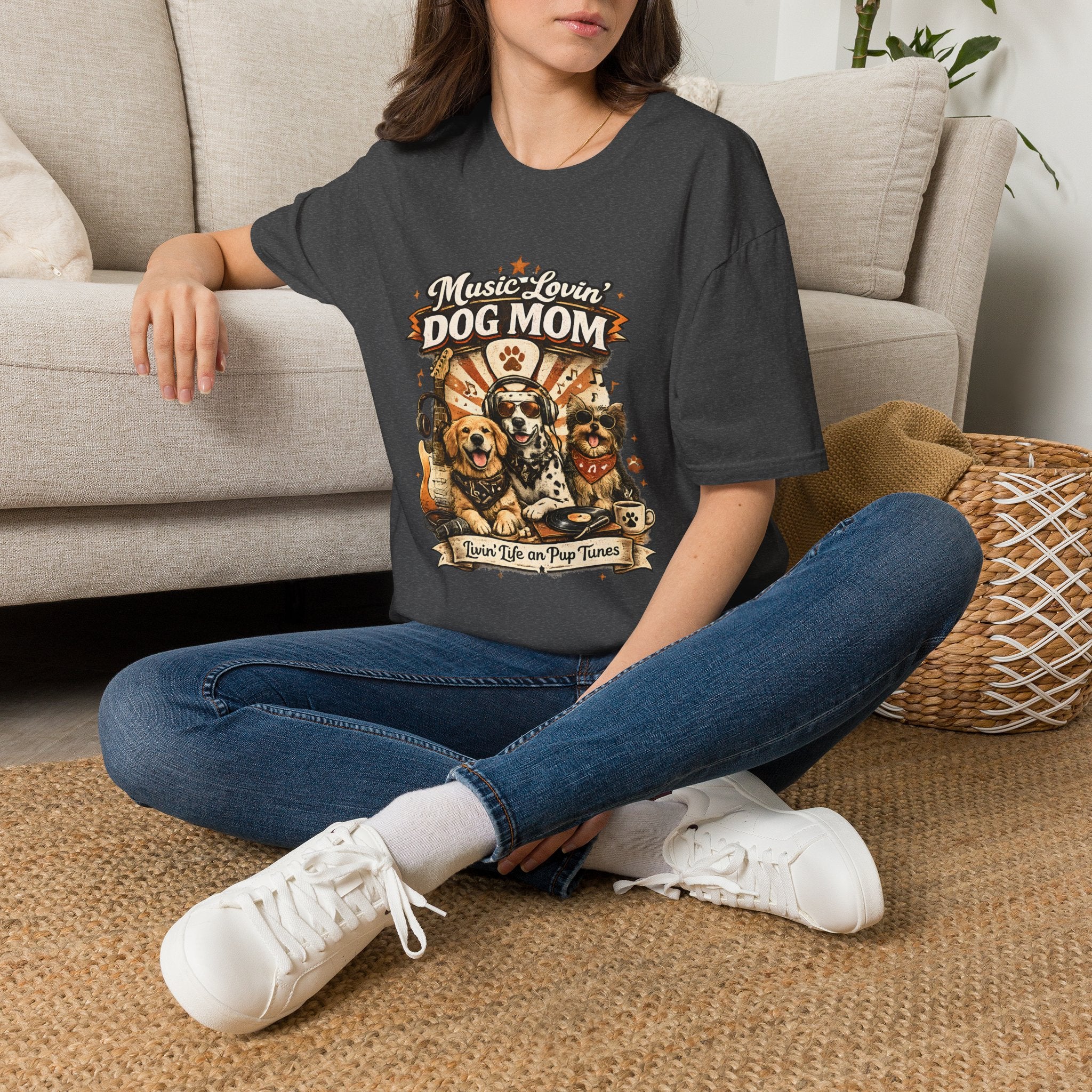 Person wearing a t-shirt with a graphic design sitting on the floor.