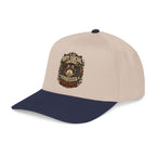 A structured baseball cap with a light beige crown and a navy blue curved brim, featuring a detailed graphic on the front that reads 'ANTI SOCIAL TYPERelationship Destroyed' in a distressed design.