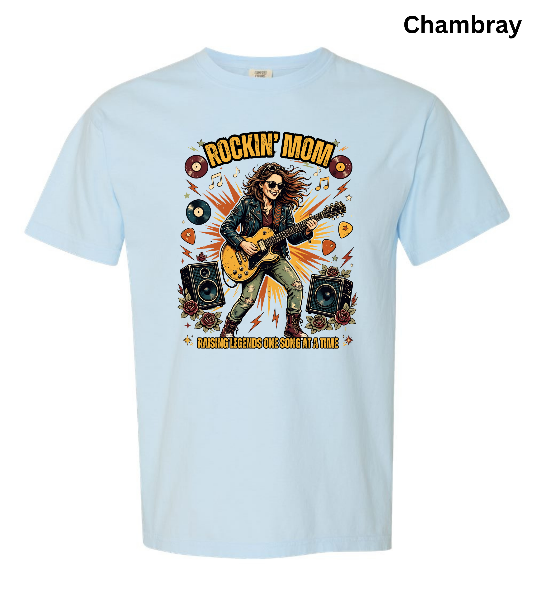A light blue short-sleeve t-shirt with a colorful graphic of a rock star playing an electric guitar, surrounded by guitars, speakers, and the text 'ROCKIN' MOM' and 'PASSION FUELED ROCKIN' GUITAR'. The word 'Chambray' is printed in black in the top right corner.