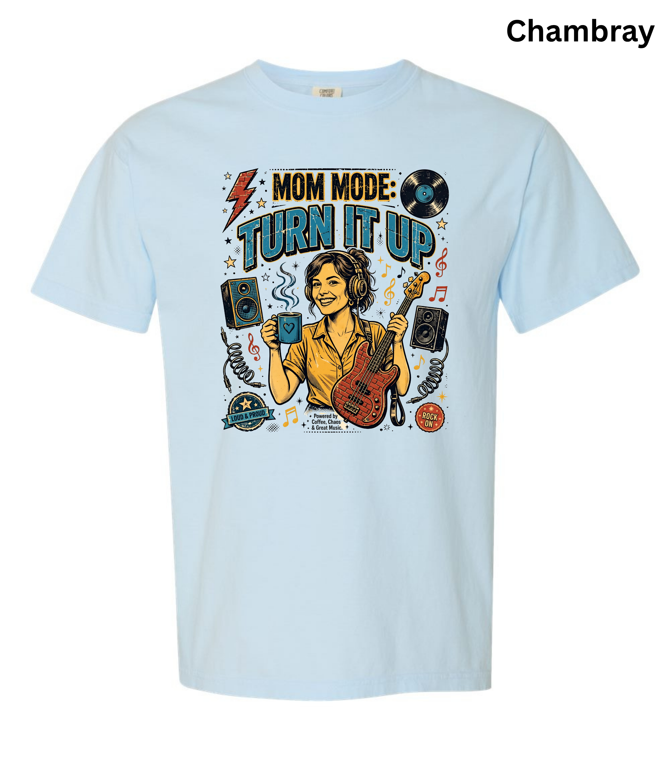 A light chambray blue short-sleeve t-shirt with a colorful graphic on the front featuring a woman playing an electric guitar and the text 'MOM MODE: TURN IT UP'.