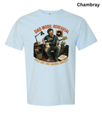 A light blue short-sleeve t-shirt with a graphic of a man playing guitar in a rehearsal room, with the text 'DAD MODE: REHEARSAL' and 'STILL GOT THE GROOVE (MOSTLY?)' in orange. The word 'Chambray' is printed in black in the top right corner.