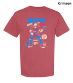 A short-sleeve crewneck t-shirt in a vibrant crimson color, featuring a colorful graphic print of a bass player on the front. The word 'Crimson' is printed in black text in the top right corner.