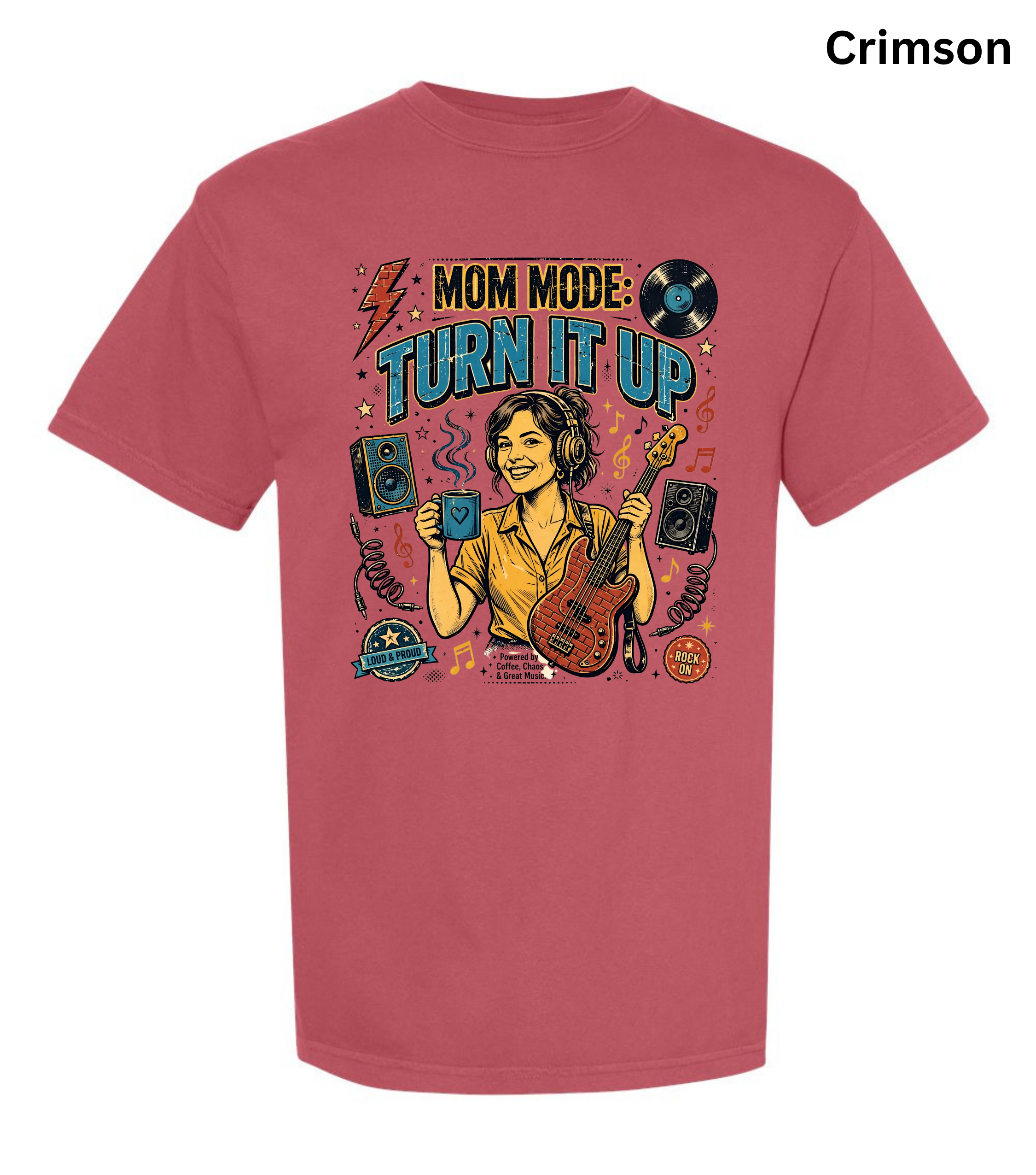 A short-sleeve crewneck t-shirt in a vibrant crimson color, featuring a colorful retro graphic of a woman playing a bass guitar with the text 'MOM MODE: TURN IT UP'. The t-shirt is displayed on a clean white background with a color label 'Crimson' in the top right corner.