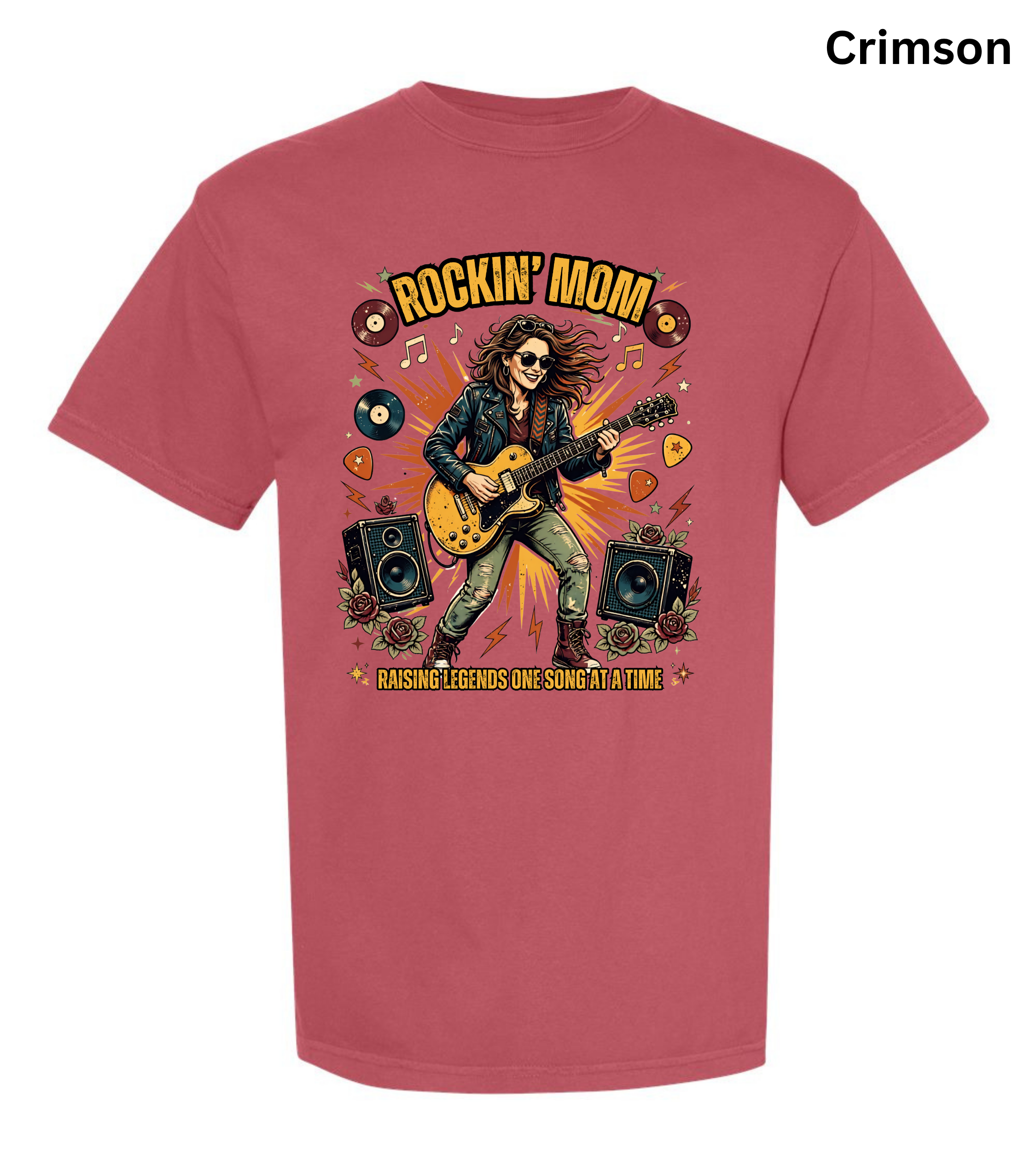 A crimson short-sleeve t-shirt with a colorful graphic of a rock star playing an electric guitar, surrounded by speakers, vinyl records, and guitar picks. The text 'ROCKIN' MOM' is printed above, and 'PASSING LEGENDS ONE SOUND AT A TIME' is printed below.