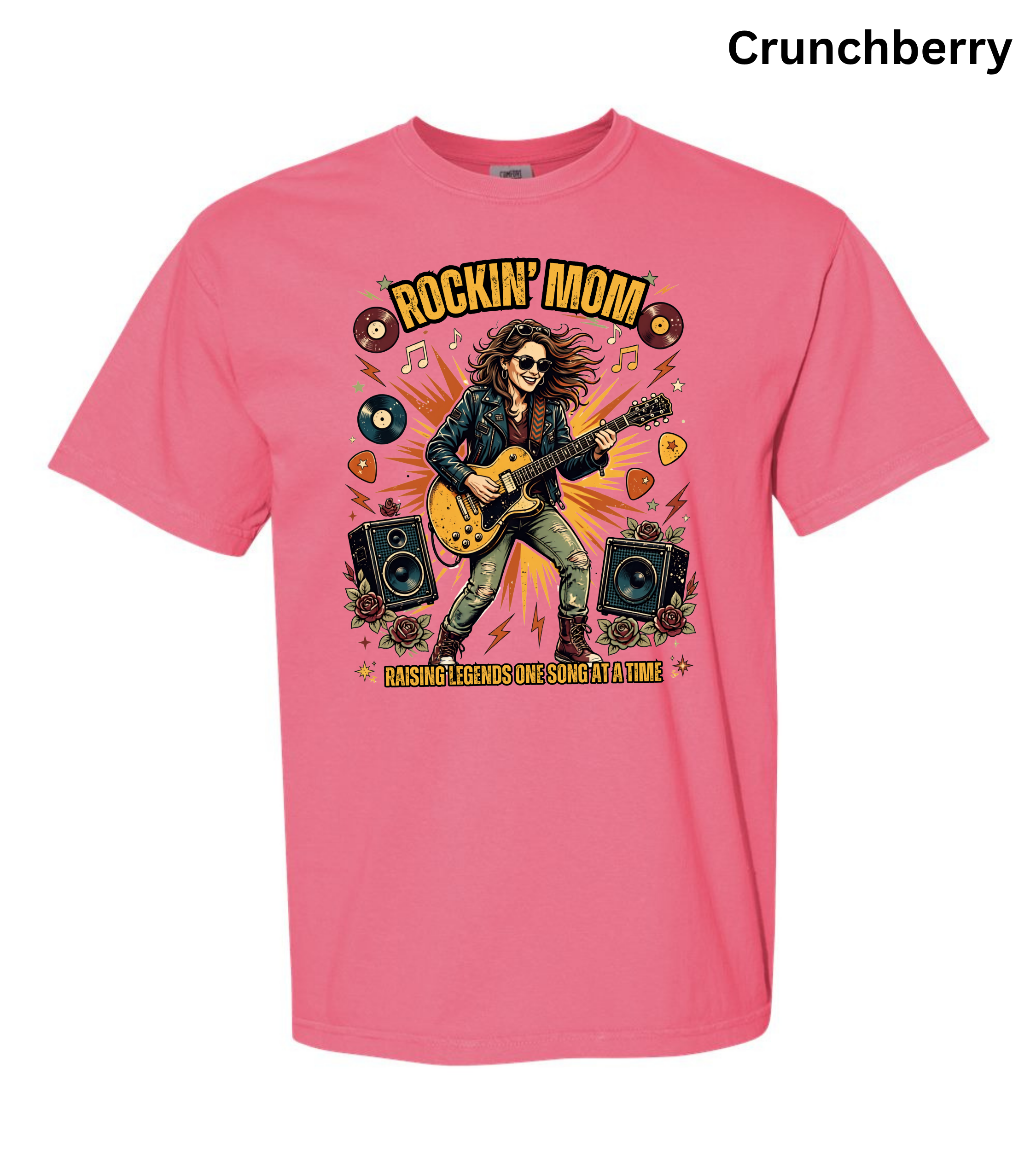 A pink short-sleeve crewneck t-shirt featuring a colorful graphic of a rock star playing an electric guitar with the text 'ROCKIN' MOM' and 'I LOVE YOURS SINCE YOU WERE 14'. The word 'Crunchberry' is printed in black in the top right corner.