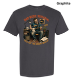 A dark charcoal gray t-shirt with a vintage-style graphic of a man playing an electric guitar in front of audio equipment. The graphic features orange text reading 'DAD MODE: REHEARSAL' and 'STILL GOT THE GROOVE (MOST!)'.
