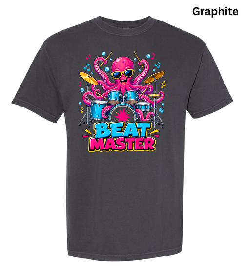 A dark charcoal gray t-shirt with a colorful graphic of a pink octopus playing a drum kit and the text 'BEAT MASTER'. The word 'Graphite' is printed in black in the top right corner.