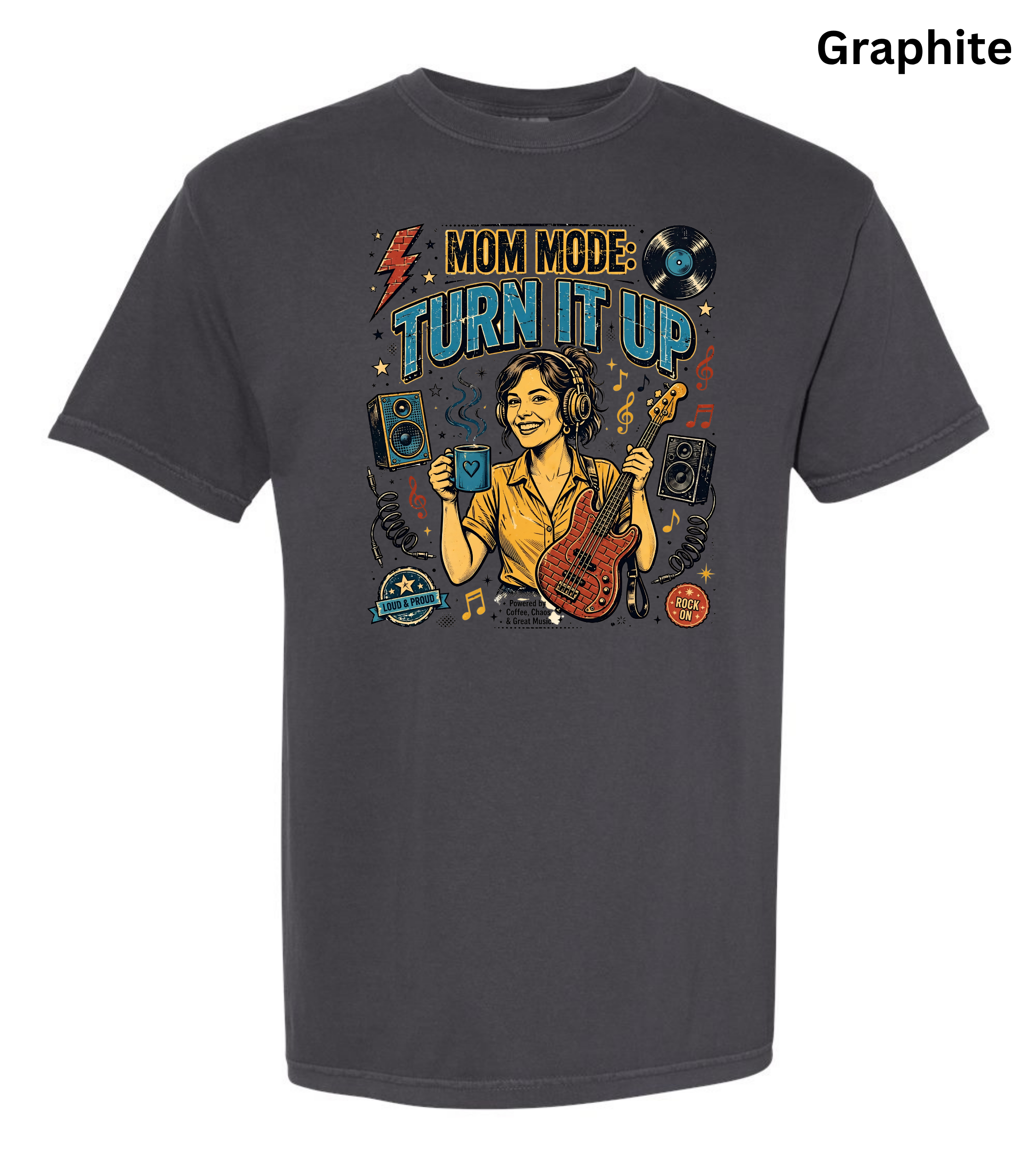 A dark gray short-sleeve t-shirt with a colorful graphic print on the front. The graphic features a woman holding a blue drink and a red bass guitar, surrounded by music-themed elements like speakers, a vinyl record, and the text 'MOM MODE: TURN IT UP'.