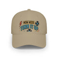 A beige baseball cap featuring a retro-style graphic on the front that reads 'MOM MODE: TURN IT UP' with vinyl records and a lightning bolt.