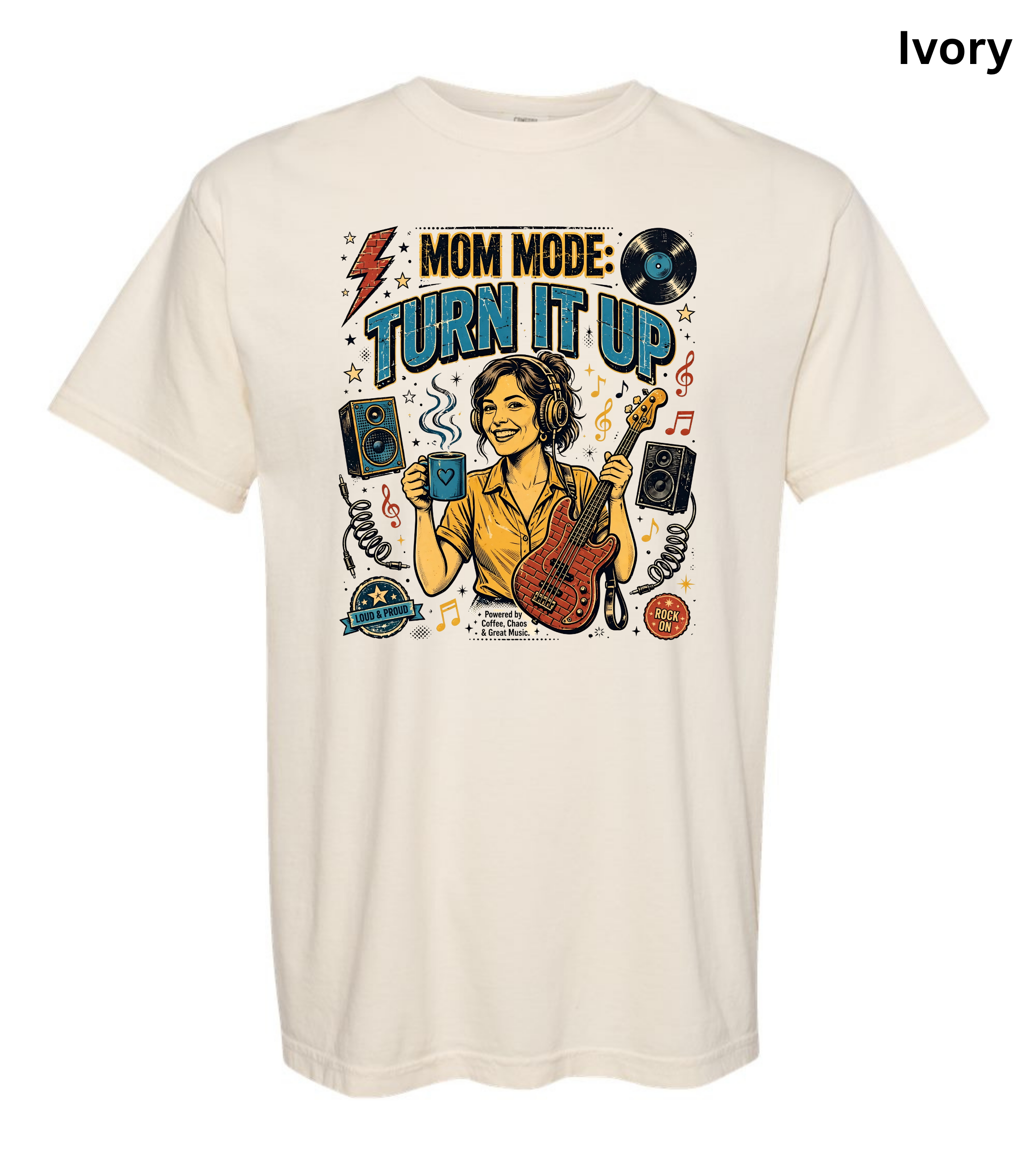 An ivory short-sleeve t-shirt with a colorful graphic print on the front featuring a woman playing an electric guitar and holding a coffee mug, surrounded by musical notes, speakers, and the text 'MOM MODE: TURN IT UP'.