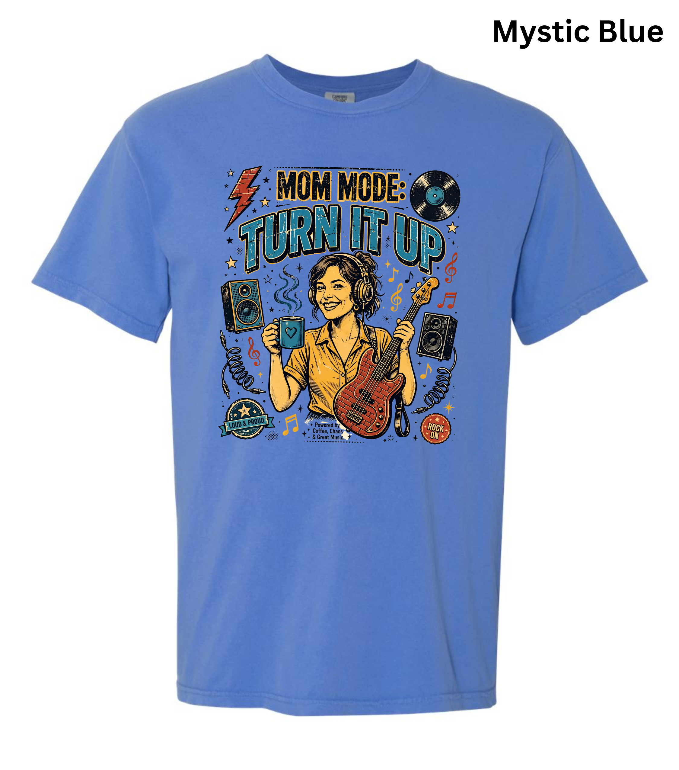 A light blue graphic t-shirt featuring a retro-style illustration of a woman playing an electric guitar with the text 'MOM MODE: TURN IT UP'. The t-shirt is displayed on a clean white background with a text label 'Mystic Blue' in the top right corner.