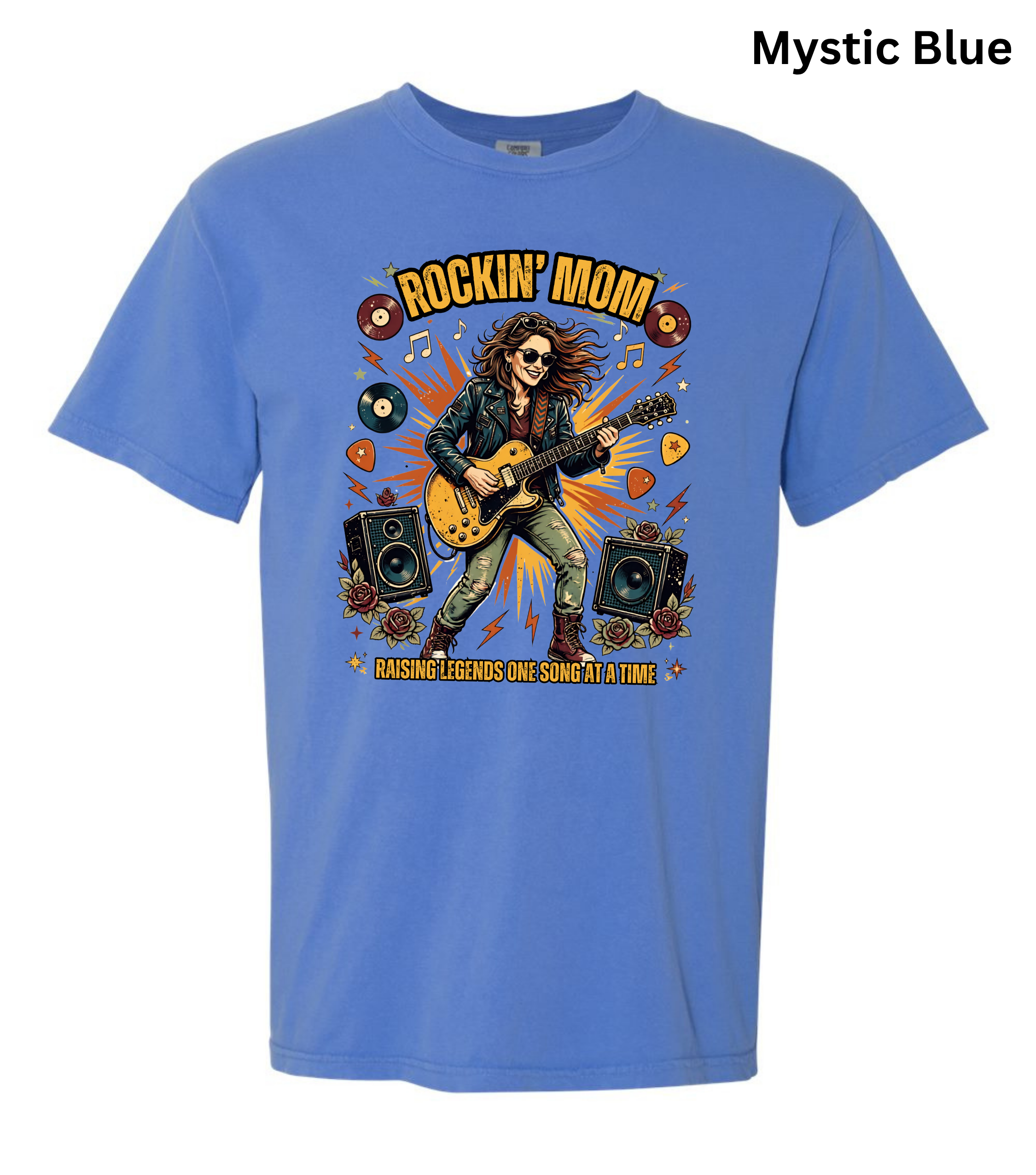 A short-sleeve crewneck t-shirt in a dusty 'Mystic Blue' color, featuring a colorful graphic of a rock star playing an electric guitar with the text 'ROCKIN' MOM' and 'BASSING TEENIES ONE SOUND AT A TIME'.
