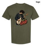 An olive sage green short-sleeve t-shirt with a graphic of a guitarist playing and the text 'PLAY IT LOUD' in red, yellow, and black, shown on a white background with a 'Sage' color label in the top right corner.