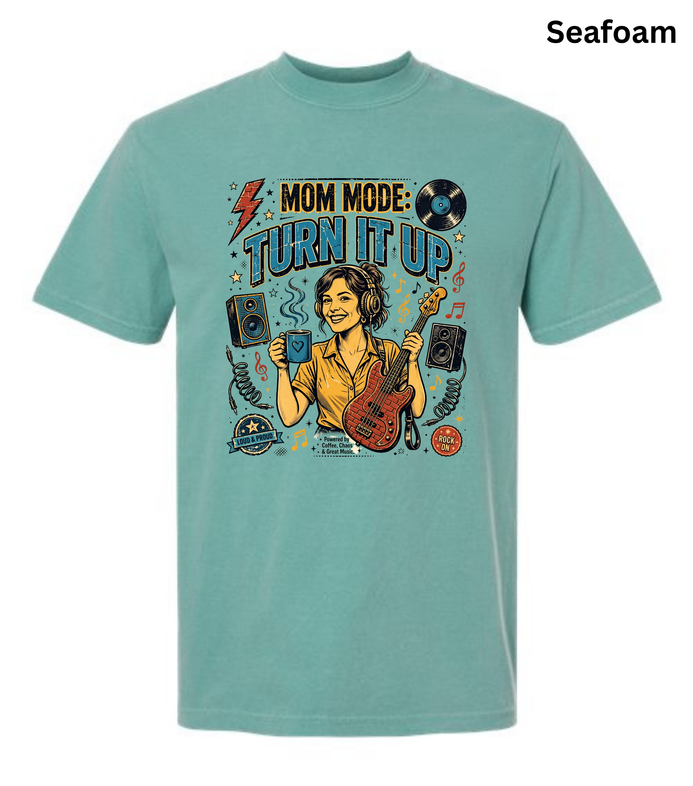 A seafoam green short-sleeve t-shirt with a colorful graphic on the front that reads 'MOM MODE: TURN IT UP' featuring an illustration of a woman playing guitar and holding a drink. The word 'Seafoam' is printed in black in the top right corner.