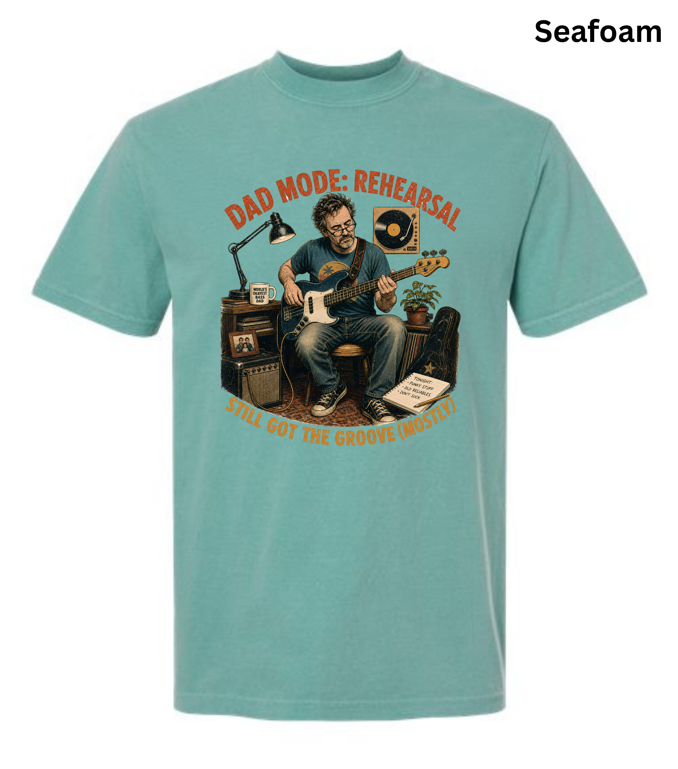 A seafoam green short-sleeve t-shirt with a vintage-style graphic of a man playing an electric guitar in a music studio. The graphic features the text 'DAD MODE: REHEARSAL' and 'TILL DEATH DO US PART'.