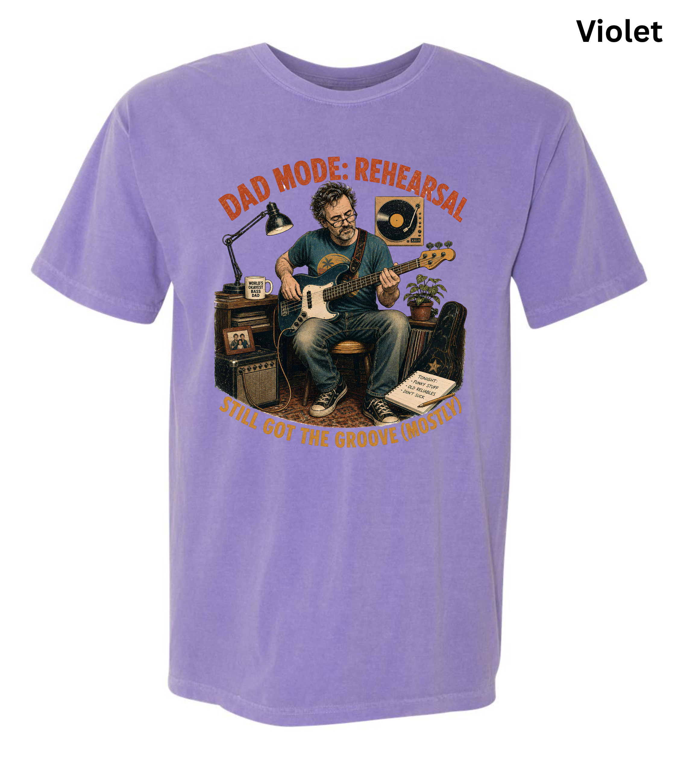A light purple short-sleeve crewneck t-shirt featuring a colorful graphic of a man playing an electric guitar with the text 'DAD MODE: REHEARSAL' and 'WILL GOT THE BLOODY MATTER?' in orange and yellow lettering.