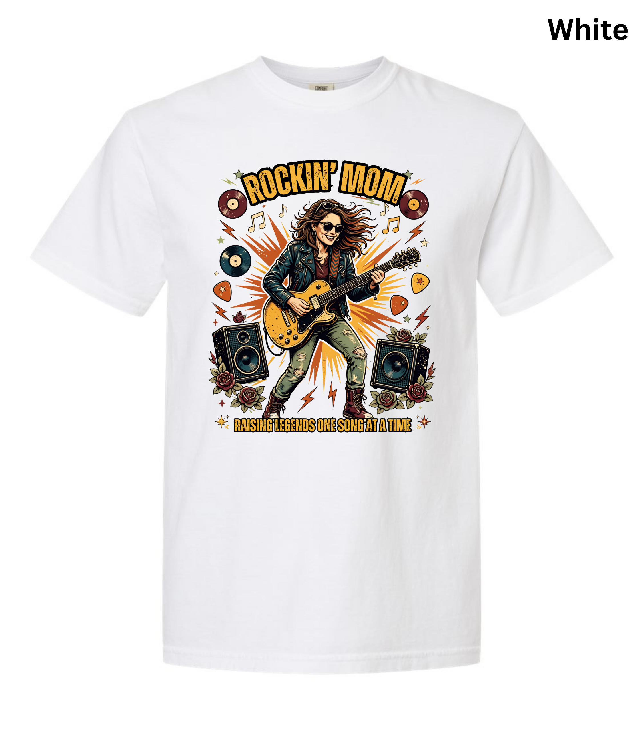 A white short-sleeve crewneck t-shirt featuring a colorful graphic of a rock star playing an electric guitar, surrounded by speakers, vinyl records, and musical notes. The text 'ROCKIN' MOM' is printed above the illustration, and 'BASSING BEHAVIOR IS NOT A GAME' is printed below.