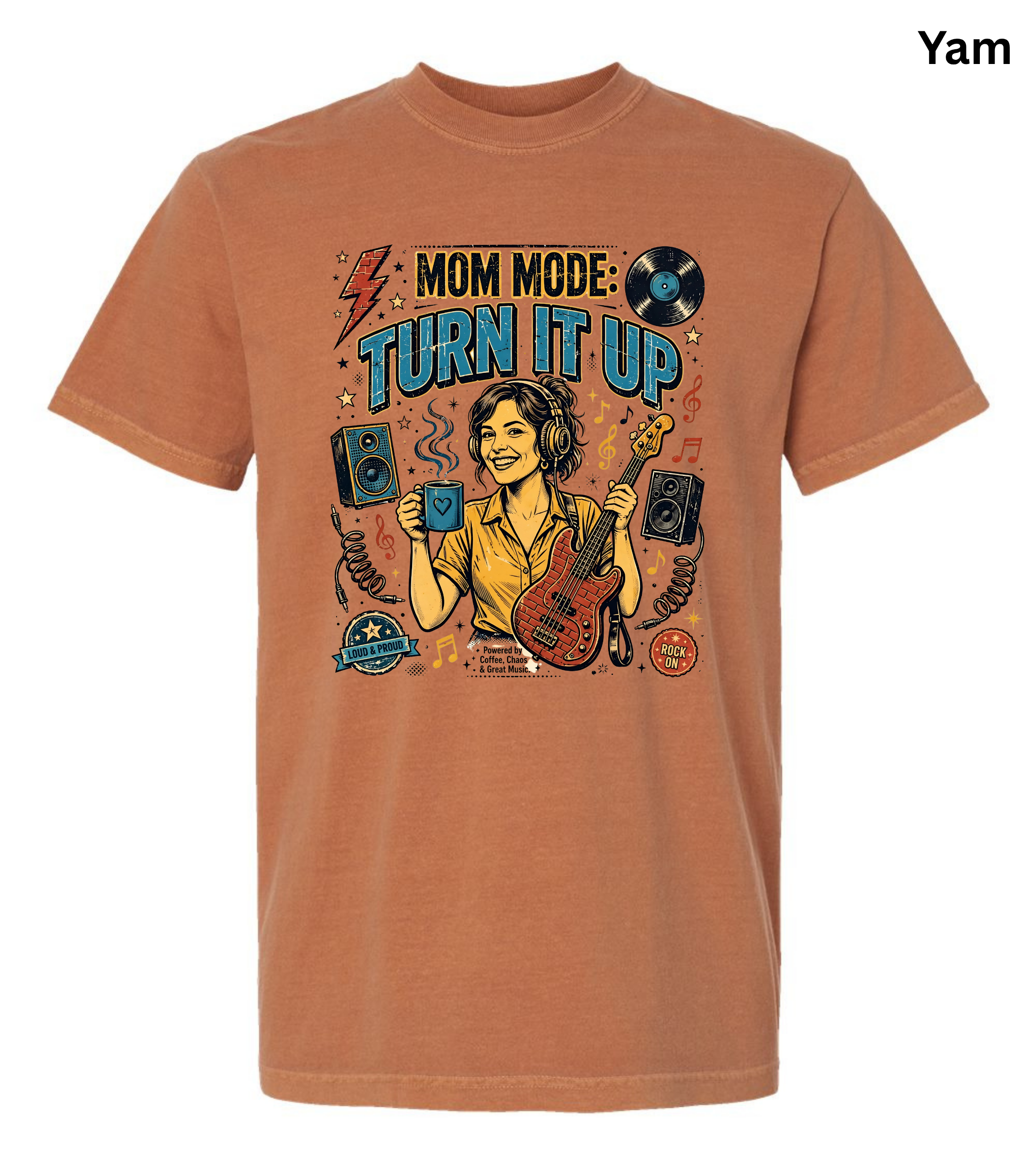 A rust-orange crewneck t-shirt featuring a colorful graphic print of a woman playing an electric guitar with the text 'MOM MODE: TURN IT UP'. The shirt is displayed on a clean white background with a small 'Yam' brand label in the top right corner.