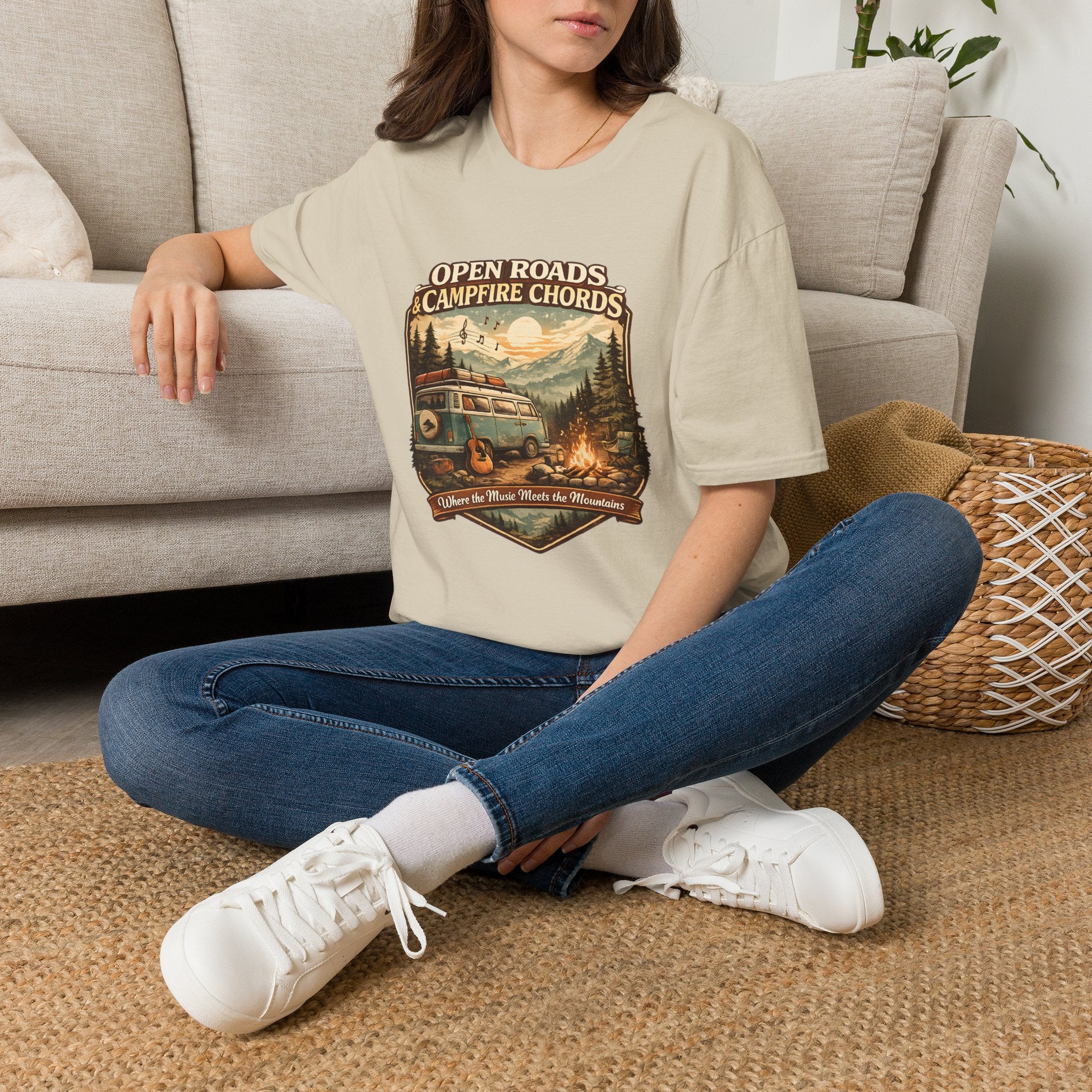 Person wearing a t-shirt with a dog graphic and text sitting on the floor.
