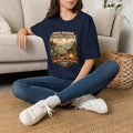 Person wearing a green t-shirt with a graphic design sitting on a carpeted floor.