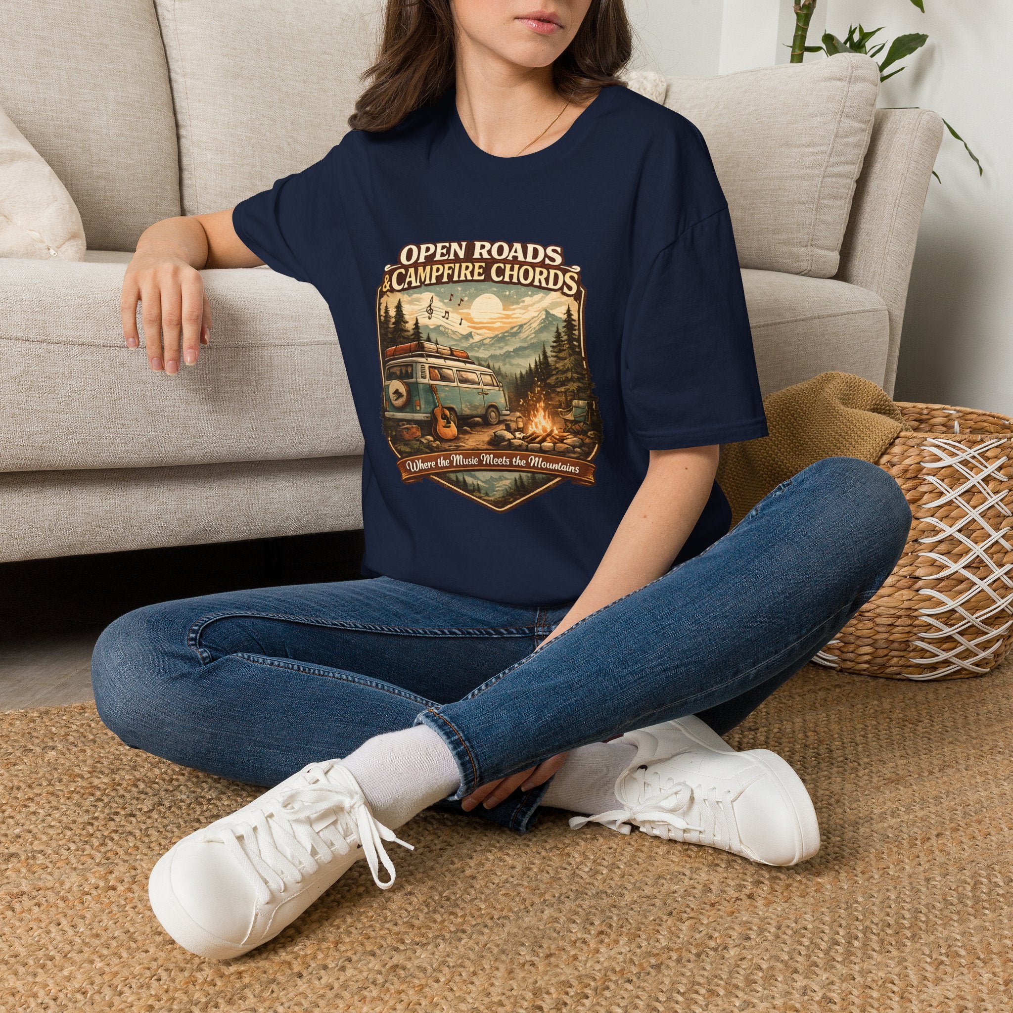 Person wearing a green t-shirt with a graphic design sitting on a carpeted floor.
