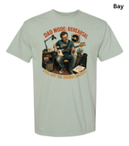 A light sage green crewneck t-shirt with a vintage-style graphic of a man playing an electric guitar in a rehearsal studio. The graphic features the text 'DAD MODE: REHEARSAL' at the top and 'STILL GOT THE GROOVE INSTINCT!' at the bottom.