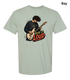 A light sage green t-shirt with a graphic of a man playing an electric guitar and the text 'PLAY IT LOUD' in red, yellow, and black. The word 'Bay' is written in the top right corner.